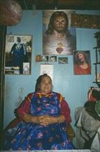 CHILE, Araucania Region, Temuco, Portrait of Mapuche woman Dona Herminda in her home.