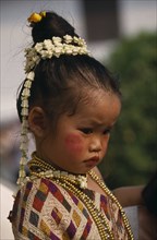 LAOS, Luang Prabang, Portrait of young girl dressed for New Year celebrations.