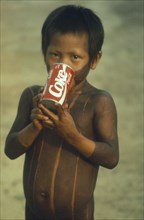 BRAZIL, Para, Amazon, Kayapo child with can of Coca Cola.