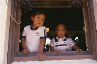 AUSTRALIA, New South Wales, Sydney, Two Tongan boys framed by window of Free Church of Tonga.