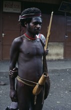 INDONESIA, Irian Jaya, Baliem Valley, Wamena.  Dani warrior wearing penis gourd.
