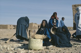 NIGER, Tribal People, Group of Tuareg women with basket of grain.