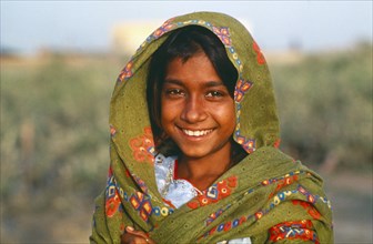 PAKISTAN, Sindh Province, Portrait of smiling Gypsy girl.