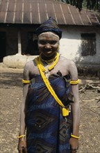 SIERRA LEONE, People, Full length portrait of a smiling Mende girl a society initiate.