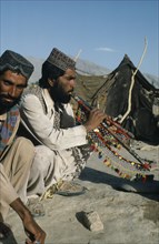 PAKISTAN, Music, Afghan man playing traditional pipes.