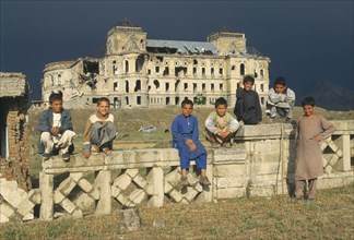 AFGHANISTAN, Kabul, Group of boys in front of heavily damaged Kabul Palace.