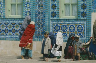 AFGHANISTAN, Balkh Province, Mazar-e Sharif, Women and children outside the Blue Mosque.