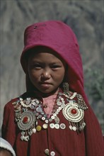 AFGHANISTAN, Nomadic People, Head and shoulders portrait of young Kirghiz girl.