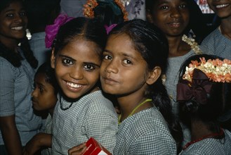 INDIA, Tamil Nadu, "Portrait of two school girls, others behind."