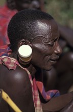 KENYA, , A maasai man at an intiation ceremony for the Moran coming into manhood with ears