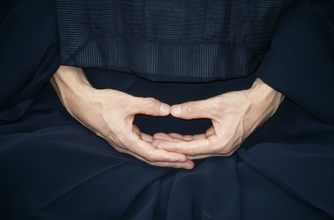 JAPAN, Zen, Cropped view of monk in Zen Buddhist monastery showing hands in Mudra the position of