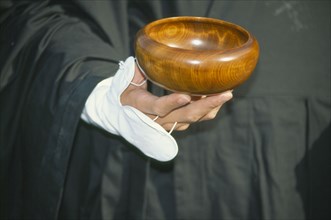 JAPAN, Obama, Cropped view of Zen Buddhist monk holding bowl for collection of alms.