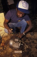 KENYA, Loitokitok, A mechanic repairs an electric motor