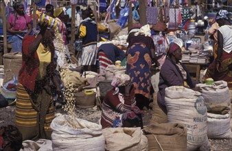 KENYA, Loitokitok, Market scene with female vendors selling grains and food products from sacks