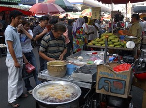 MALAYSIA, Kuala Lumpur, Chinatown, Market stalls selling various foodstuffs with customers waiting