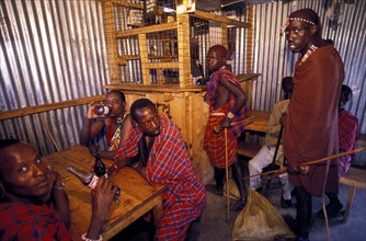 KENYA, Near Kajiado, Maasai Moran drinking in a bar. Alcoholism is a particular problem amongst the