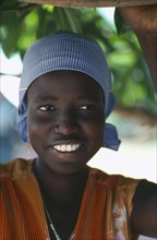 SUDAN, People, Portrait of smiling Dinka girl wearing striped headscarf.