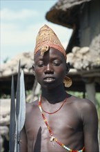 SUDAN, Tribal Peoples, Portrait of Dinka boy holding spears.