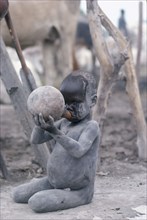 SUDAN, Tribal Peoples, Dinka child drinking milk from gourd.