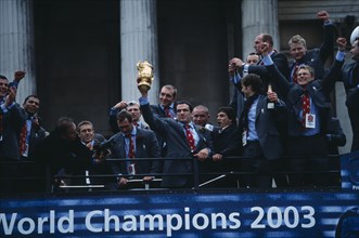 20048554 ENGLAND  London The winning Rugby World Cup 2003 team on top of a bus holding the trophy during a celebratory procession