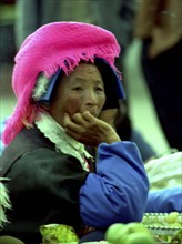 CHINA, Yunnan, Zongdian, Portrait of a female street vendor wearing a pink hat