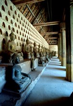 LAOS, Vientiane, View along row of seated Buddha statues at Wat Si Saket