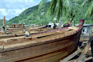 VIETNAM, South, Nha Trang, Building a new fishing fleet with half built wooden ships in the