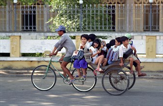 VIETNAM, South, Chau Doc, Cyclo transporting several children to or from school