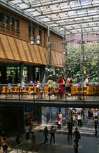GERMANY, Berlin, Potsdamer Platz. Cafe on mezzanine floor in Daimler City with shoppers below
