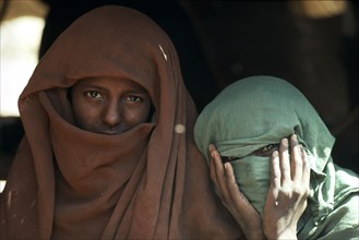 SUDAN, Red Beahills , Portrait of two veiled Beja nomad women.