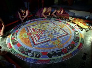 INDIA, Sikkim, Rumtek Gompa, Several monks painting decorative patterns for the Pujar ceremony  and
