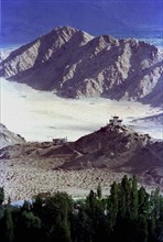 INDIA, Ladakh, Leh, View toward distant Temples on the outskirts of the town against a backdrop of