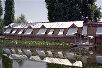 INDIA, Kashmir, Srinagar, Nagin Lake. Large modern houseboat with window shades