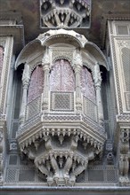 INDIA, Rajasthan, Jaisalmer, Detail of elaborate hand carved window frame of the Patwon Ki Haveli