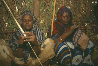 KENYA, Tribal Peoples, Local women making clothing.