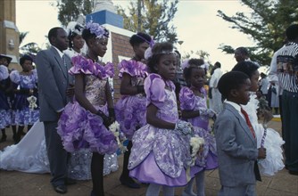 UGANDA, Rubanga, Christian wedding ceremony.  Bride and groom with bridesmaids and page boys