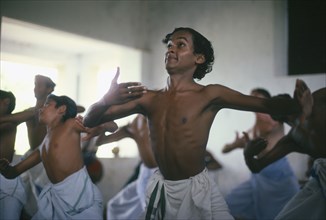 INDIA, Kerala, Dance, Young men training for Kathakali dance.