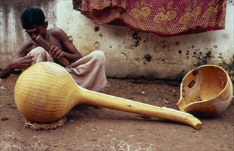 INDIA, Tamil Nadu, Craftsman making musical instrument..