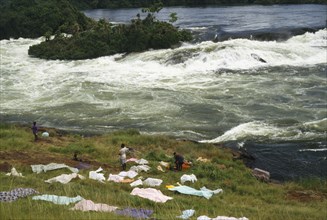 UGANDA, Bujagali Falls, View over the river and source of the Nile with people drying cloths on the