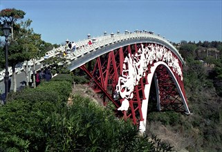 SOUTH KOREA, Cheju do Island, Peace Bridge. View along the red iron footbridge decorated with white