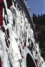 SOUTH KOREA, Cheju do Island, Peace Bridge. Detail of white carved figures adorning the side of the