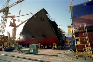 SOUTH KOREA, Pusan, Dae-woos new ship building yard with section of ship surrounded by cranes