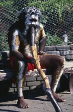 AUSTRALIA, New South Wales, Blue Mountains, Aborigine man with a didgeridoo busking for money at