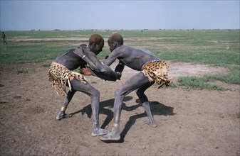 SUDAN, Tribal People, Dinka tribesmen wrestling.