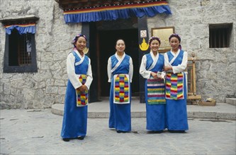 CHINA, Guandong, Shenzhen, Tibetan women standing outside the Folk Culture Villages Theme Park