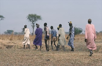 SUDAN, Wedding, Dinka bridegroom in purple with members of his clan who will negotiate a bride