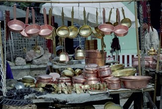 CHINA, Yunnan, Lijiang, Close up of pots and pans displayed on a household goods market stall