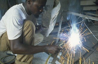 TANZANIA, Shinyanga, Man electric arc welding