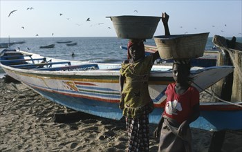 GAMBIA, Fishing, Girls carrying buckets of fish on their heads