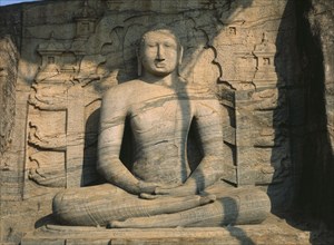 SRI LANKA, Polonnaruwa, Gal Vihara.  Mid twelth century seated Buddha figure carved from granite.